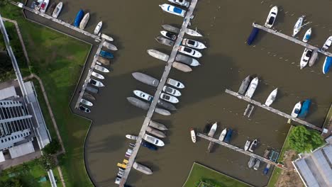 drone rotation over dozens of ships berthed at dock of a private club