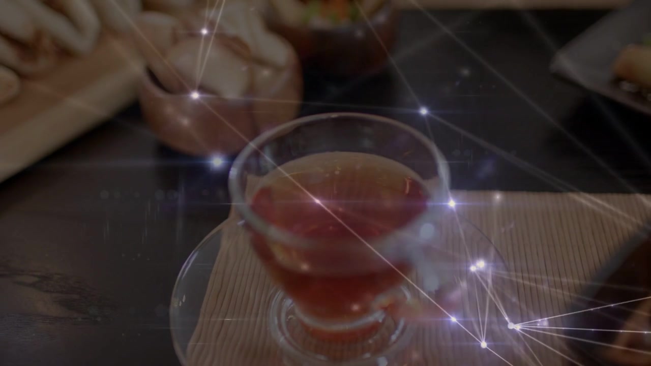 Camera panning and overlay drifting revealing glass teacup, centering amber tea from baos for menu