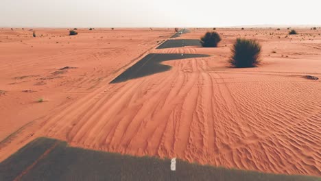 4k drone footage, a road between desert, dubai’s half desert road, geological landscape of high dune desert in the united arab emirates, drone videos