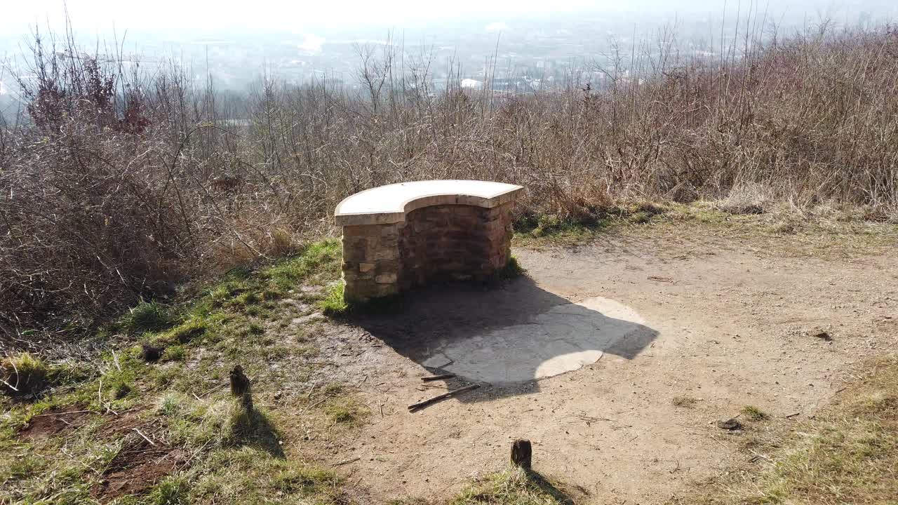 A serene landscape view from Plateau de Malzéville, overlooking the expansive cityscape below, with a clear sky and natural surroundings.