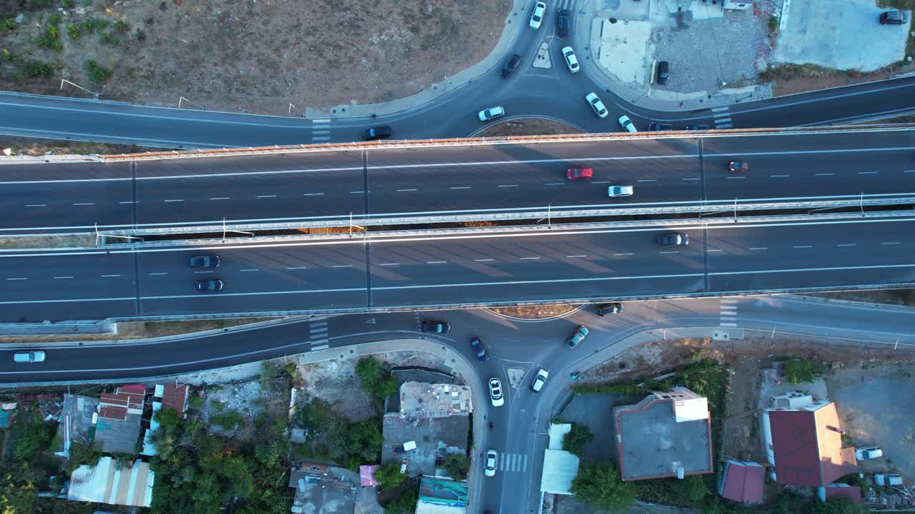 Drone top view of Tirana ring road highway in twilight, suburban traffic, urban transport, and infrastructure