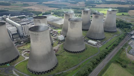 establishing aerial view ratcliffe-on-soar nuclear power station steaming cooling towers emissions