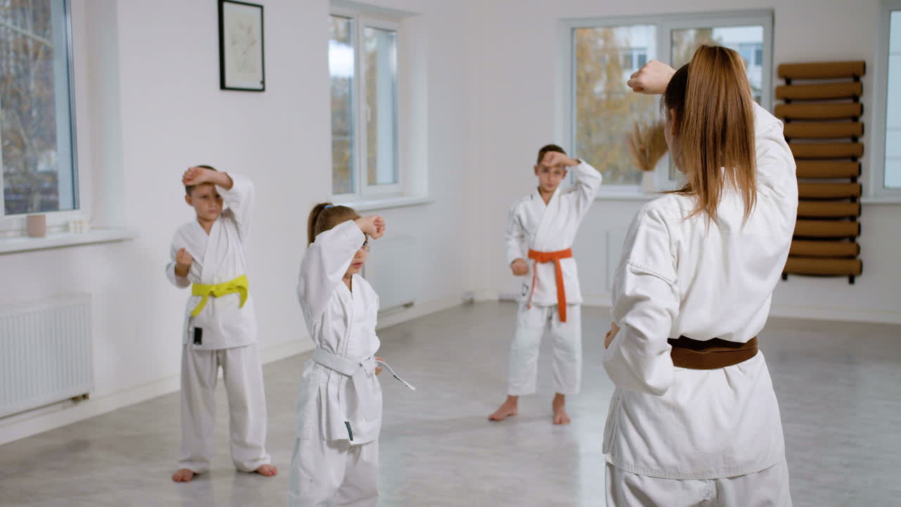 Kids in white kimono in martial arts class