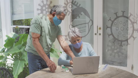 animación de iconos de covid 19 sobre una pareja mayor usando una computadora portátil con máscaras faciales