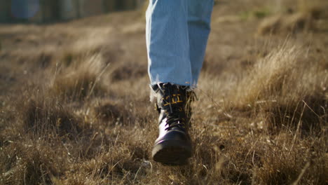 Woman-legs-going-meadow-vertical-closeup.-Unknown-lady-walking-in-autumn-nature