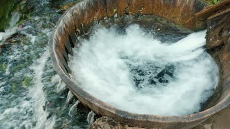 Close-up-of-gushing-water-through-wooden-chute