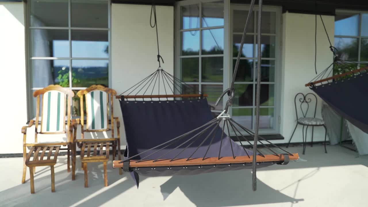 Follow Shot Around Two Hammocks On Cosy Porch. Slow Motion