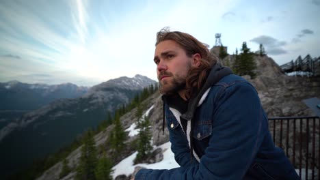 smiling young man looking out over jasper national, alberta, canada