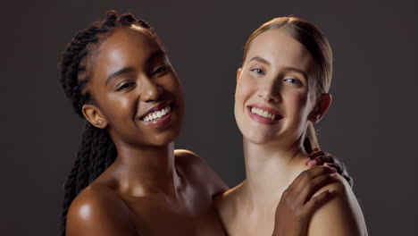 two beautiful women of different ethnicities smiling together