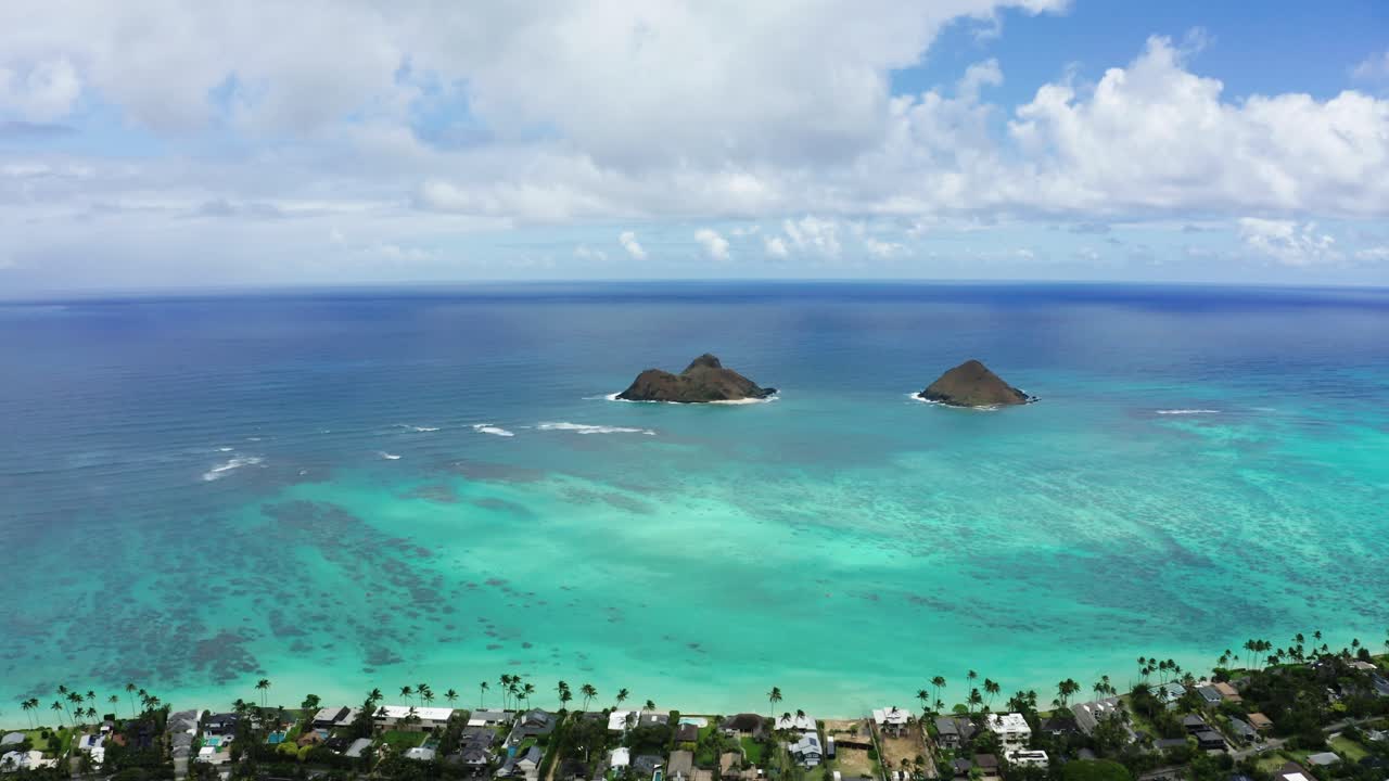 Drone shot of Moku Nui and Moku Iki islands off the coast of Oahu, panning to show the size of the ocean