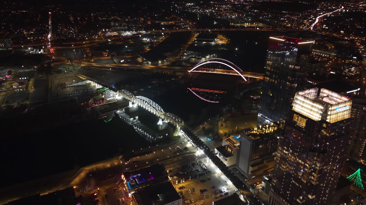 Establishing drone shot of the illuminated bridges of Nashville, night in USA