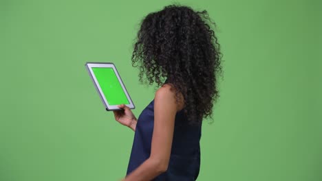 young beautiful hispanic businesswoman using digital tablet