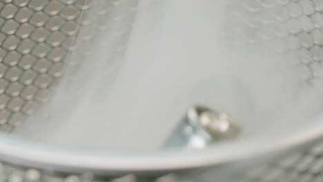 silver batteries aa and aaa in wastebasket with smoke around close-up. double-a battery is a standard size single cell cylindrical dry battery. batteries are common in portable electronic devices. environmental impacts of lithium-ion batteries concept. an aa battery is composed of a single electroch