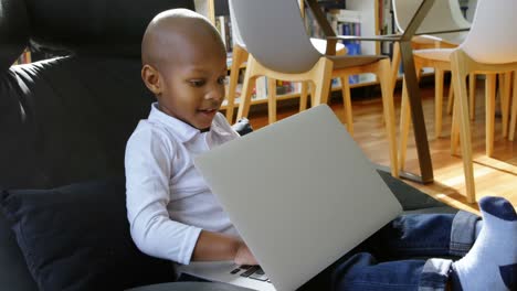 Boy-using-laptop-in-a-comfortable-home-4k