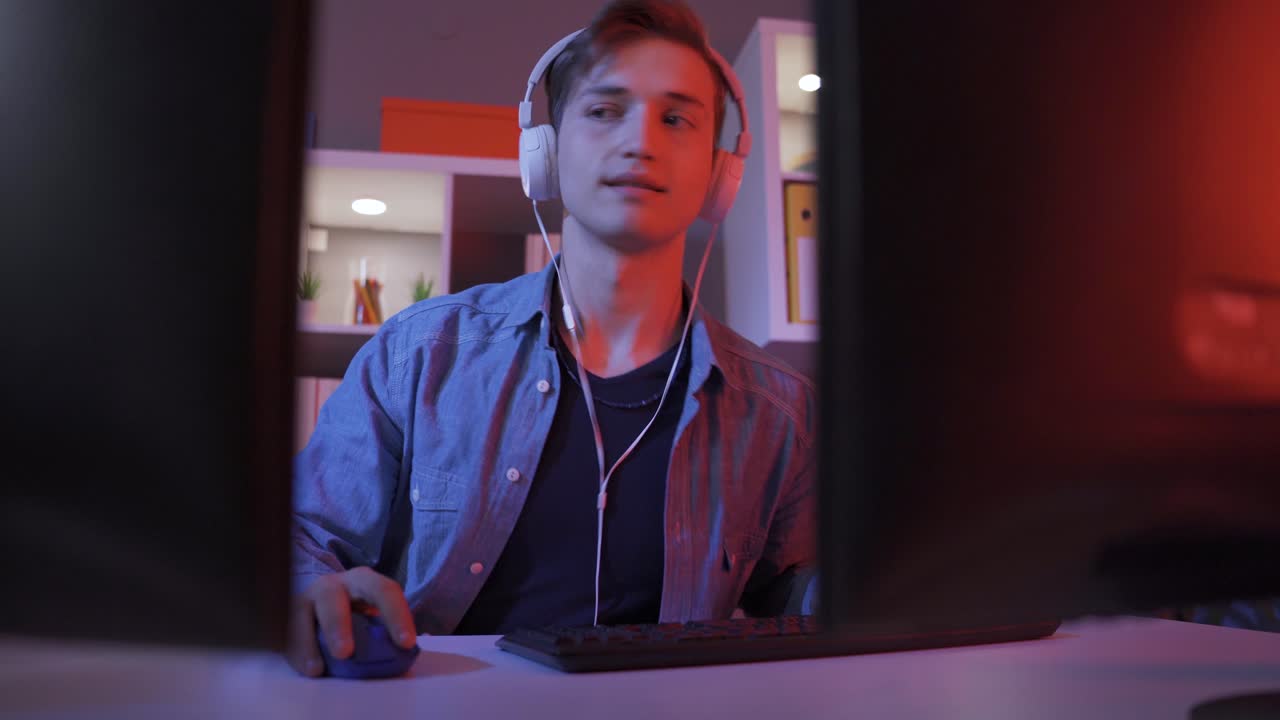 Exciting Male Gamer Playing Online Video Game on Computer.