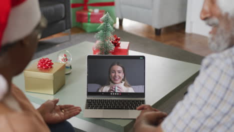 Happy-african-american-senior-couple-on-video-call-with-female-friend-at-christmas