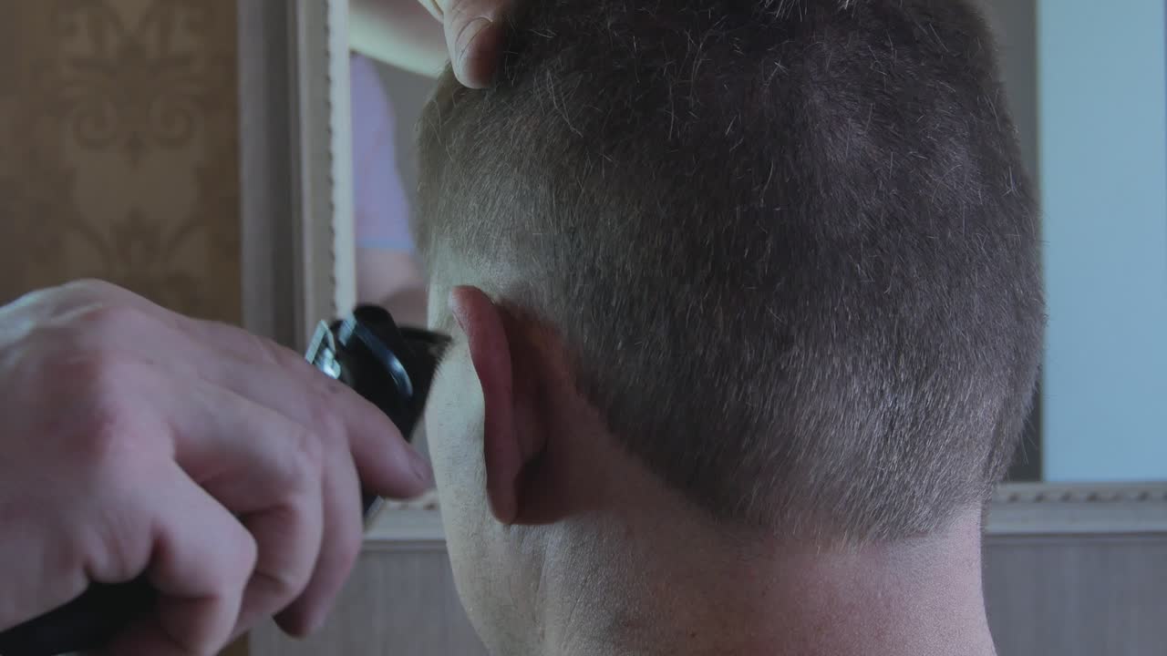 Perform a Haircut Contour Above the Ears with an Electric Machine. 4K Footage
