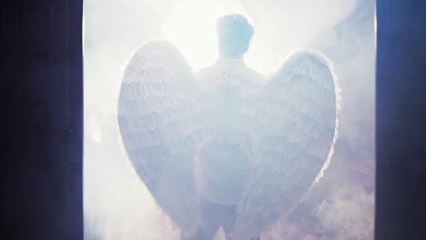 cinematic back shot of a lgtb man with angel wings and a white light in the background in a smoke ambient