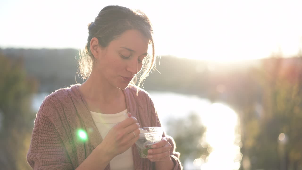 Woman eating chia pudding in the park on a sunny day