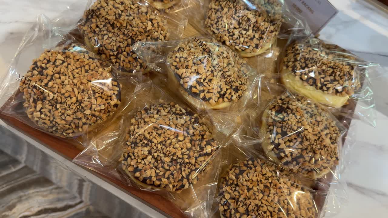 Close-Up of Packaged Chocolate Peanut Donuts on Display
