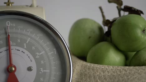 kitchen weighing scales with apples medium panning shot