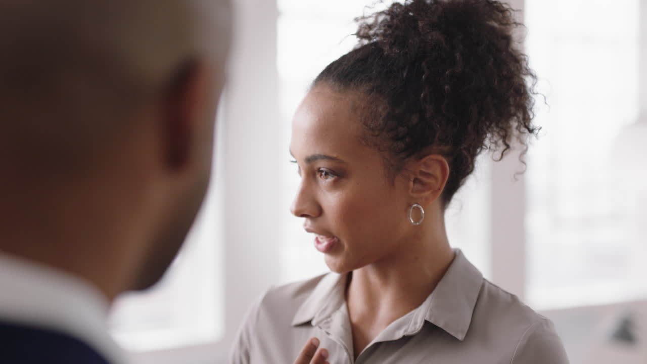 beautiful mixed race business woman chatting with clients smiling enjoying developing corporate partnership discussing project in modern office workspace