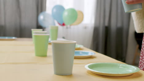 woman and boy setting the table