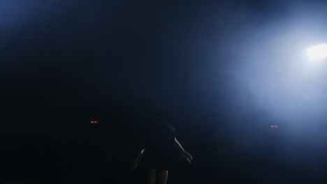 professional gymnast girl performs a jump with a spin on the balance beam in slow motion.