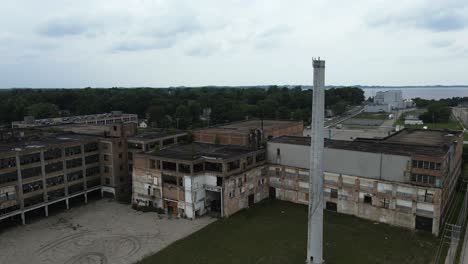 abandoned factory area, downward jib motion to show off soggy stones