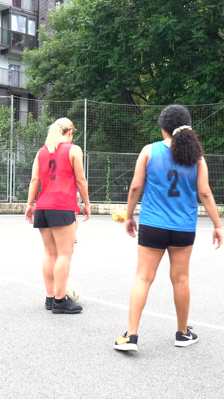 Women playing soccer outdoors