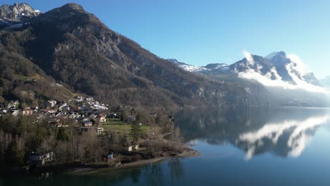 Drone-clip-of-mountains-and-lake,-showing-water-cycle-of-evaporation,-precipitation-as-snow-and-melting-to-lake-water