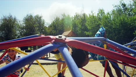 schoolkids playing on dome climber in playground