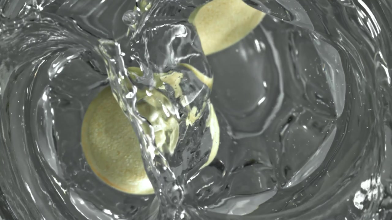 Due compresse effervescenti che si dissolvono in acqua, vista dall'alto