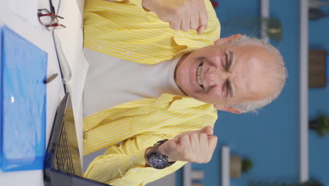 Vertical-video-of-Home-office-worker-old-man-having-a-nervous-breakdown.