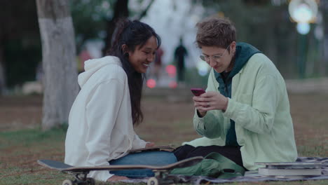 college girls using phone and chatting in the park