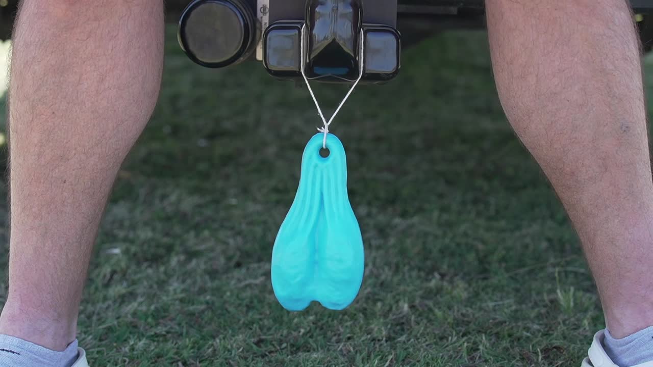 Blue plastic balls neatly arranged underneath a car, adding a playful touch to the vehicle's aesthetic