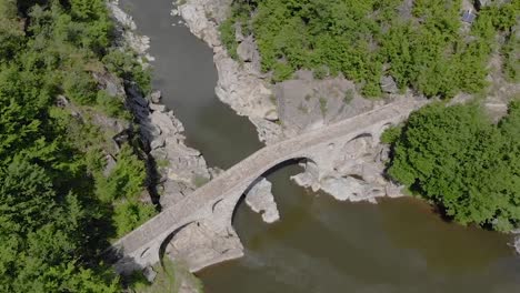 flight over the devil's birdge - an old roman bridge built in the 16th century near ardino in rhodope mountains bulgaria