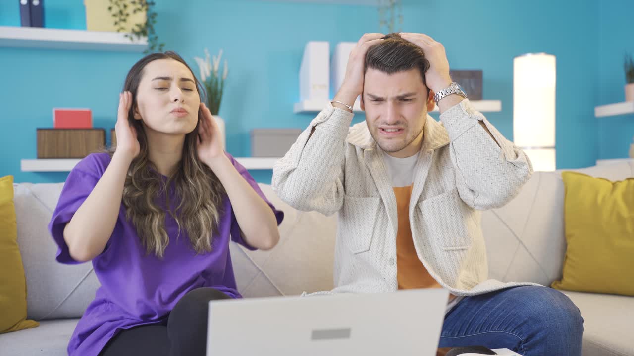 los amantes felices se entristecen. los jóvenes amantes reciben malas noticias en casa en la computadora portátil.