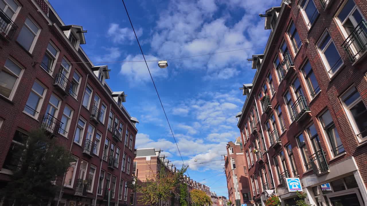 City Street with Brick Buildings and Cloudy Sky