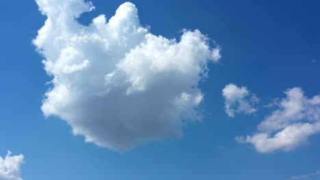 white fluffy clouds in blue clear sky