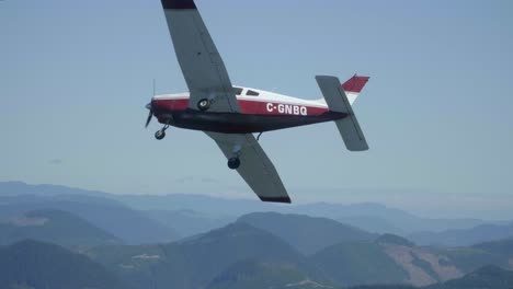 small airplane flying in formation and banking away