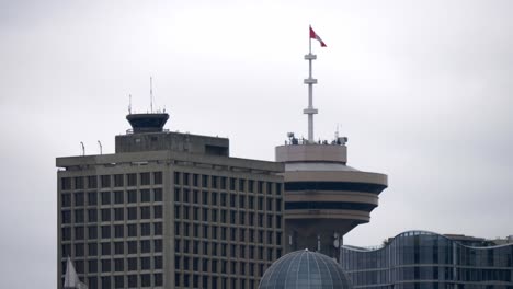 canadian flag on top of the harbour centre skyscraper in vancouver