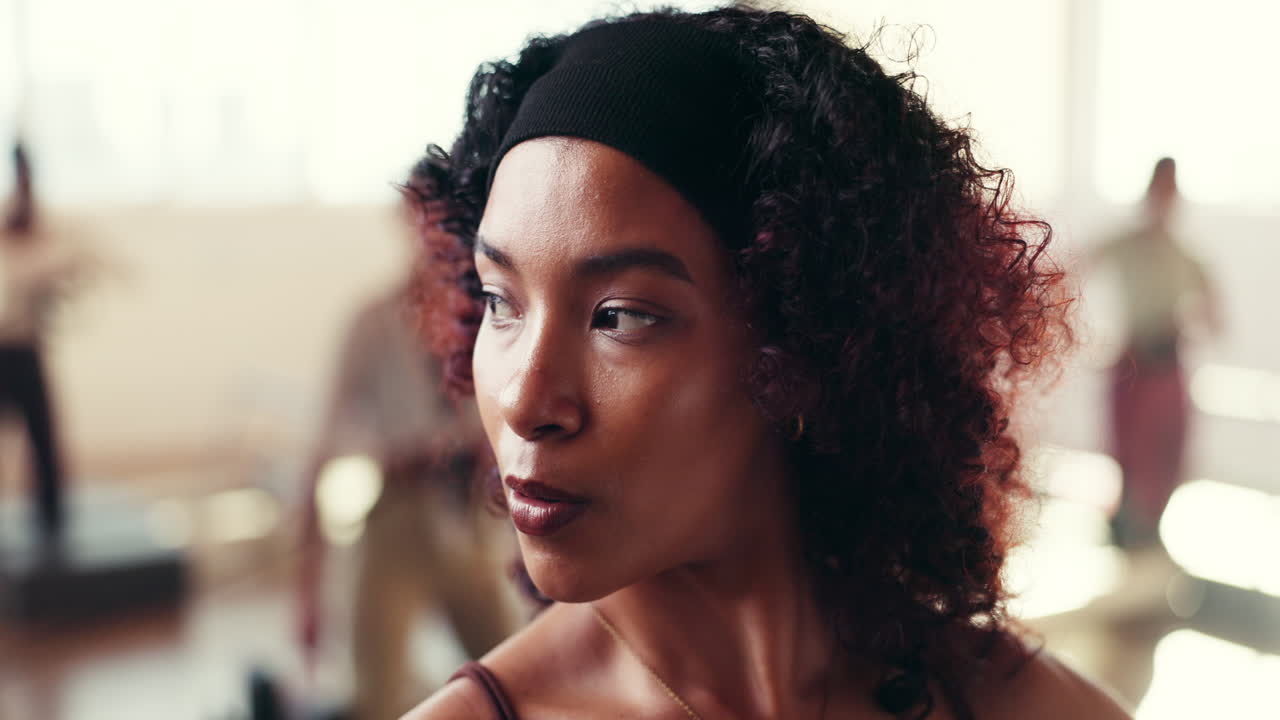 Portrait of a woman with curly hair and headband