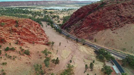 reversing drone footage over heavitree gap and the gap, a suburb of alice springs, mparntwe, with the todd river and heavitree gap in the distance. northern territory, australia. august 2022.