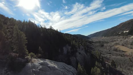 fpv drone along mountains with lens flare