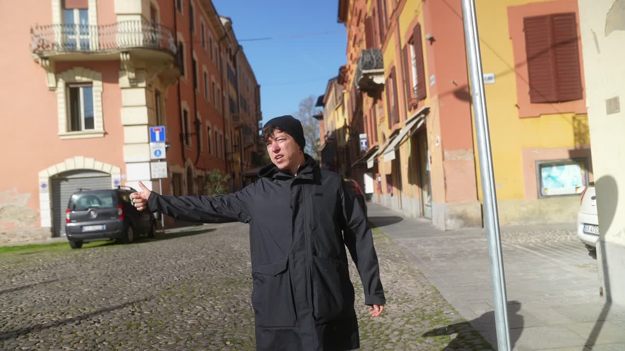 Person requesting a ride on a city street