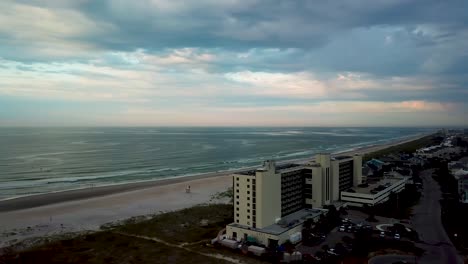 Early-morning-sunrise-drone-flyover-pan-from-right-to-left-of-beach-clouds-and-sunrise-at-shell-island-to-figure-eight-island-in-Wilmington-North-Carolina