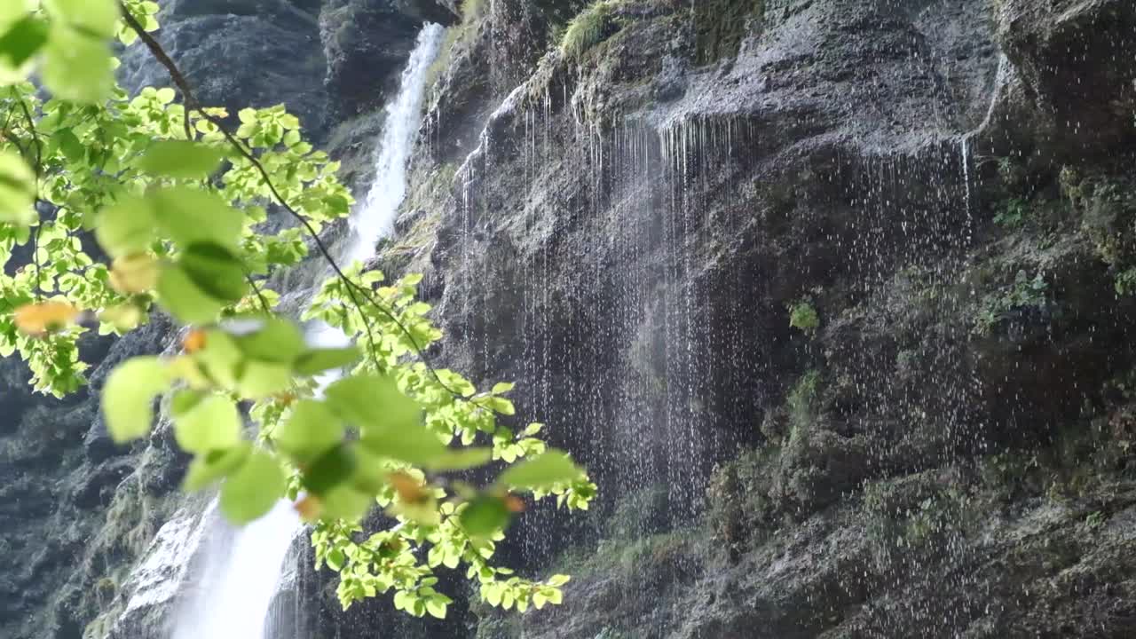 The beautiful waterfall of Pericnik Waterfall in Slovenia. Waterfall falling behind the vivids tree being lit up from the sun rays