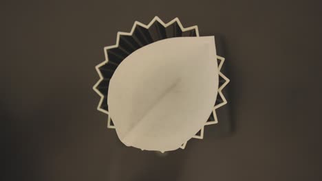 top down view of barista throw paper filter into carafe for coffee brewing