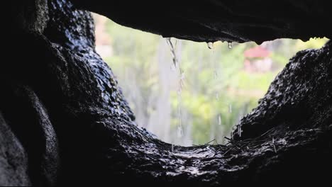 water dripping from cave into waterfall